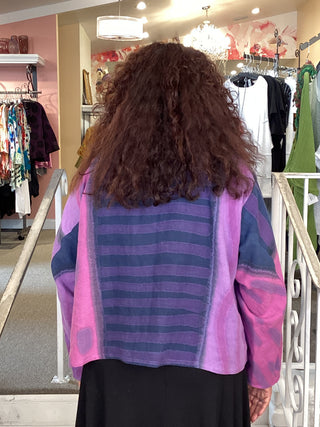 Person wearing a colorful striped garment in a store setting
